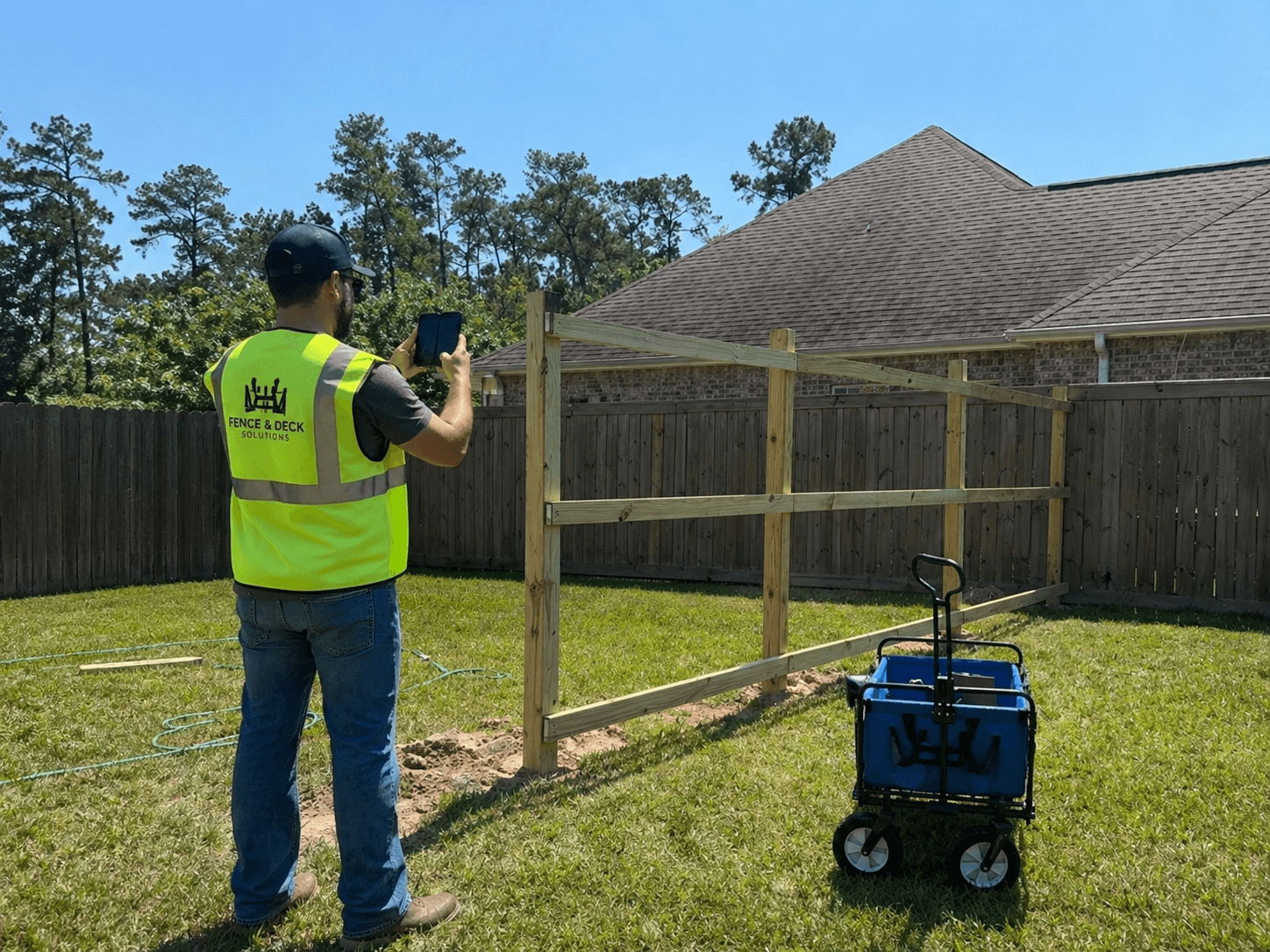 Field worker capturing job walk photos with a mobile device at a jobsite